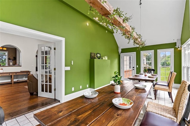 4337 Mountain View Rd, Oakwood, GA 30566 - dining area with high vaulted ceiling, tile patterned flooring, and healthy amount of natural light