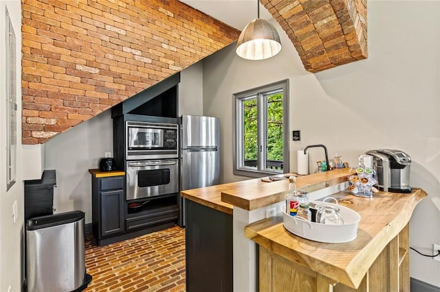 4337 Mountain View Rd, Oakwood, GA 30566 - kitchen with butcher block countertops, appliances with stainless steel finishes, brick floors, and hanging light fixtures