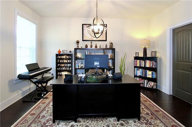 office area with a notable chandelier and dark hardwood / wood-style floors