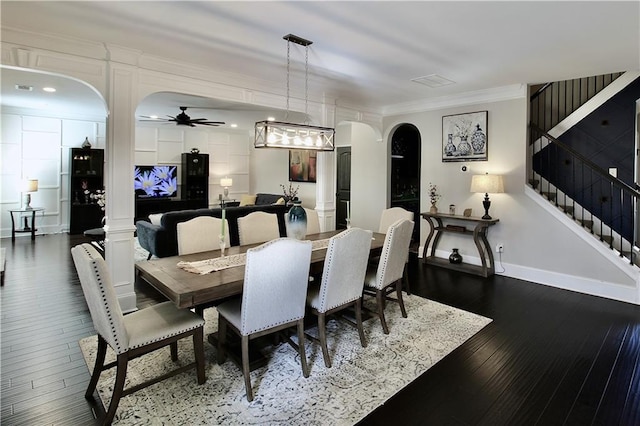 dining room featuring crown molding, wood-type flooring, decorative columns, and ceiling fan