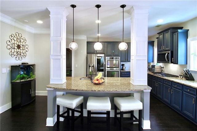 kitchen with decorative columns, backsplash, a kitchen breakfast bar, hanging light fixtures, and stainless steel appliances