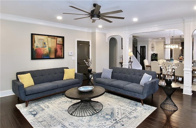 living room with ceiling fan, ornamental molding, dark hardwood / wood-style floors, and decorative columns