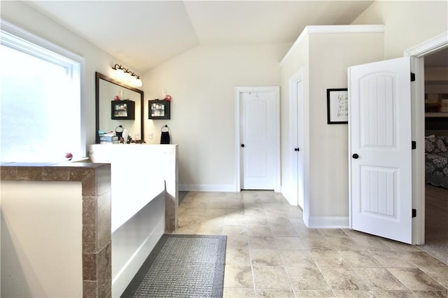 bathroom featuring lofted ceiling and vanity