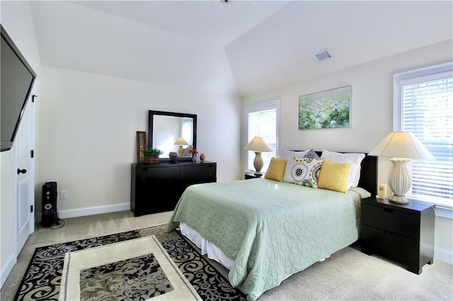 bedroom with vaulted ceiling and light carpet