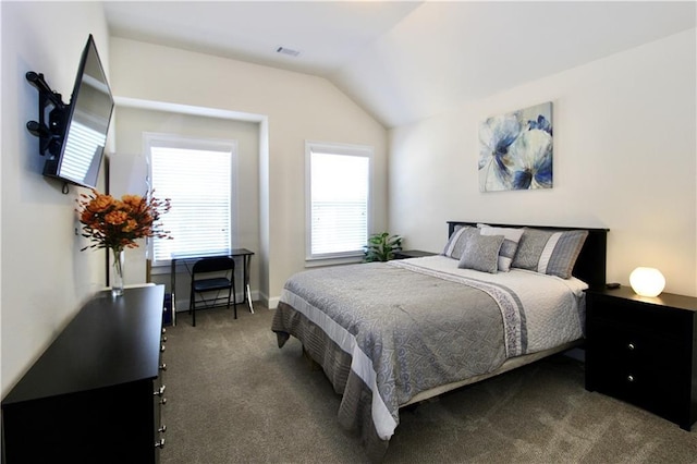 bedroom featuring lofted ceiling and dark colored carpet