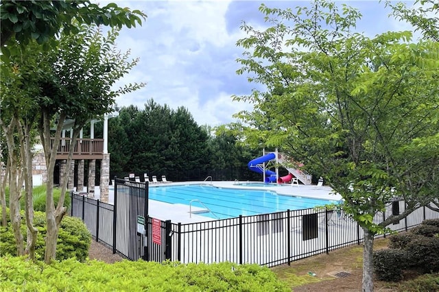 view of swimming pool with a water slide