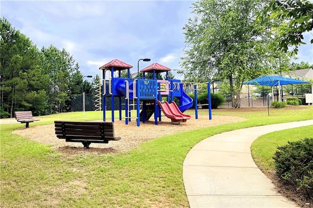 view of playground featuring a lawn