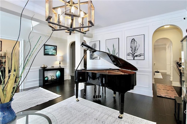 misc room with dark hardwood / wood-style flooring, ornamental molding, and a chandelier