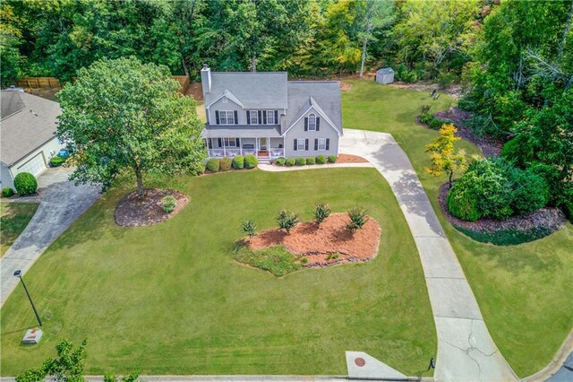 colonial home featuring a front yard and covered porch