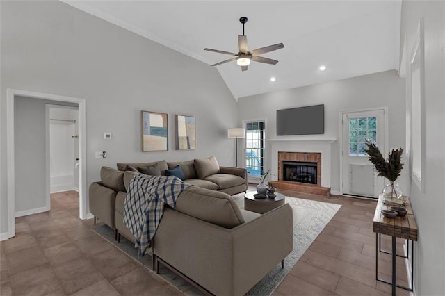 living area featuring a ceiling fan, a brick fireplace, high vaulted ceiling, baseboards, and recessed lighting