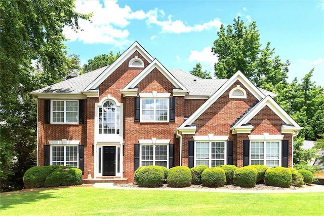 194 Lake Ruby Dr, Suwanee, GA 30024 - georgian-style home with brick siding and a front yard