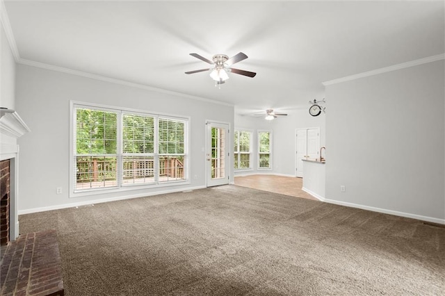 194 Lake Ruby Dr, Suwanee, GA 30024 - unfurnished living room with ceiling fan, a brick fireplace, crown molding, carpet, and plenty of natural light