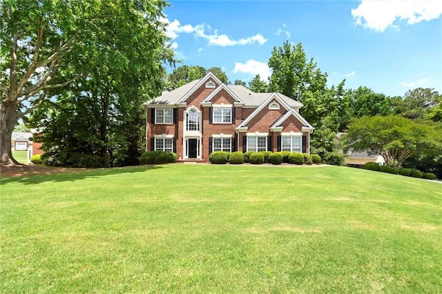 194 Lake Ruby Dr, Suwanee, GA 30024 - colonial inspired home featuring a front lawn and brick siding