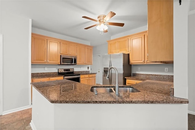 194 Lake Ruby Dr, Suwanee, GA 30024 - kitchen featuring stainless steel appliances, a sink, dark stone countertops, and ceiling fan