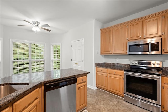 194 Lake Ruby Dr, Suwanee, GA 30024 - kitchen featuring appliances with stainless steel finishes, ceiling fan, light tile patterned floors, and dark stone counters