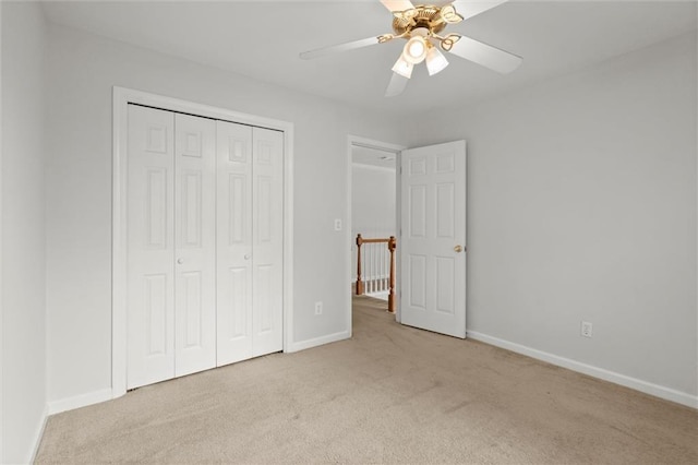 194 Lake Ruby Dr, Suwanee, GA 30024 - unfurnished bedroom featuring carpet flooring, a closet, baseboards, and a ceiling fan