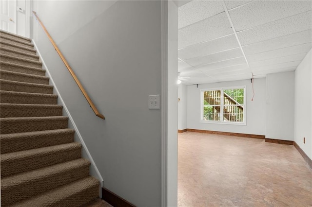 194 Lake Ruby Dr, Suwanee, GA 30024 - stairs featuring a paneled ceiling, baseboards, and finished concrete flooring