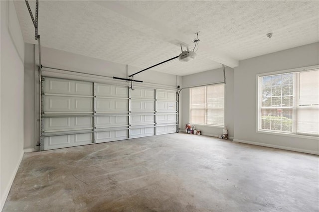 194 Lake Ruby Dr, Suwanee, GA 30024 - garage featuring baseboards and a garage door opener