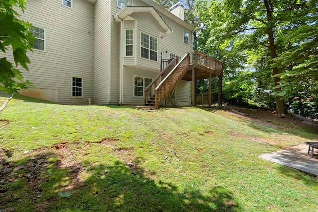 194 Lake Ruby Dr, Suwanee, GA 30024 - back of house featuring stairs, a chimney, a wooden deck, and a lawn
