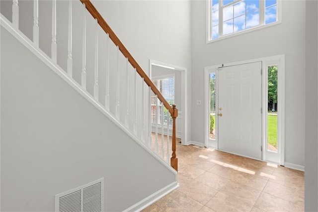 194 Lake Ruby Dr, Suwanee, GA 30024 - foyer with stairs, tile patterned floors, a high ceiling, and baseboards