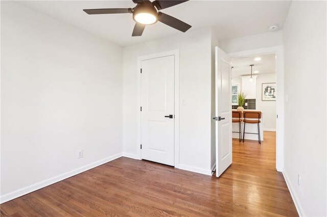 bedroom with ceiling fan and dark hardwood / wood-style flooring