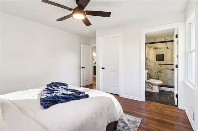 bedroom with ceiling fan, ensuite bathroom, and dark hardwood / wood-style floors