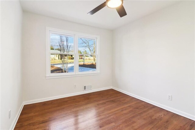 bedroom featuring ceiling fan, multiple windows, and dark hardwood / wood-style flooring