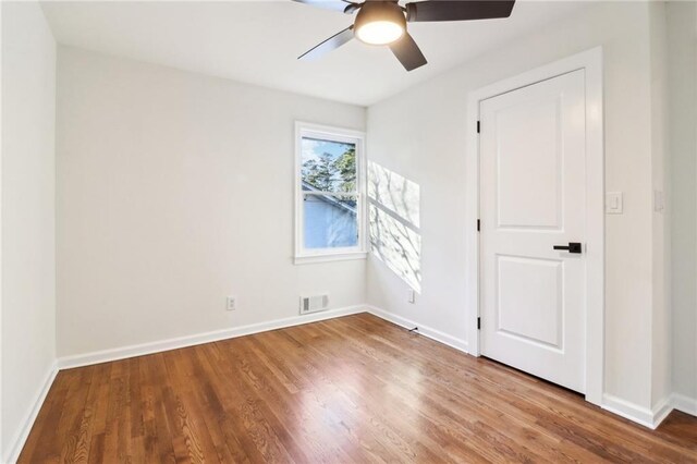 empty room with hardwood / wood-style flooring