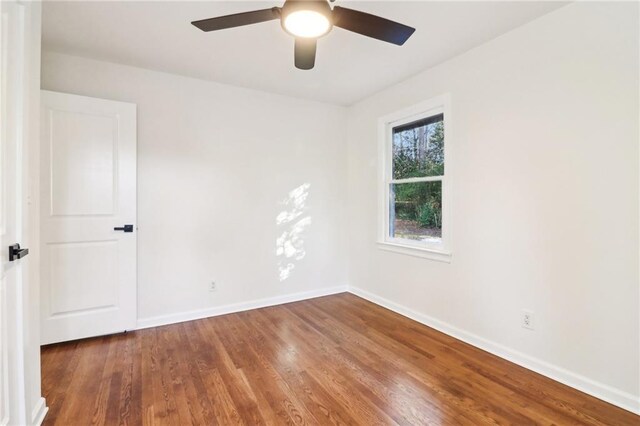 unfurnished bedroom with ceiling fan and dark hardwood / wood-style flooring