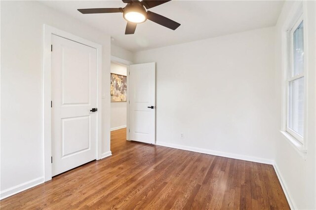 unfurnished bedroom featuring ceiling fan and wood-type flooring