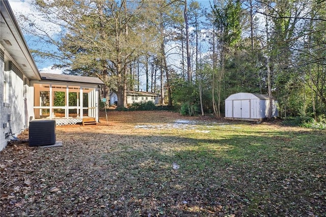 view of yard with a shed and central AC