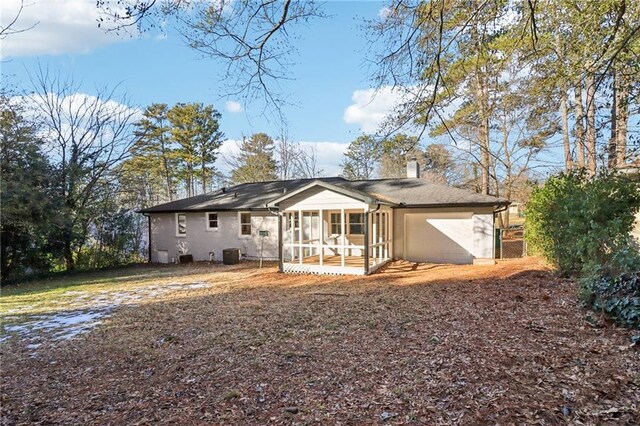 back of house featuring a sunroom and central AC