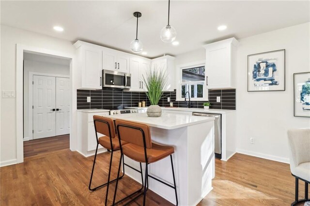 dining space featuring wood-type flooring and a notable chandelier