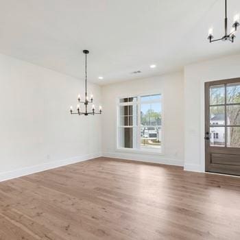 6450 Pond View Dr, Cumming, GA 30028 - unfurnished dining area with a chandelier, wood finished floors, baseboards, and recessed lighting