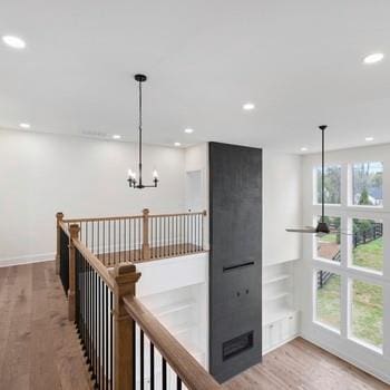 6450 Pond View Dr, Cumming, GA 30028 - hall featuring recessed lighting, wood finished floors, an upstairs landing, a chandelier, and baseboards
