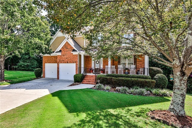 view of front of property with a garage, covered porch, and a front yard