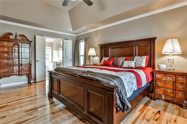 bedroom featuring light hardwood / wood-style flooring, ensuite bath, ornamental molding, ceiling fan, and vaulted ceiling