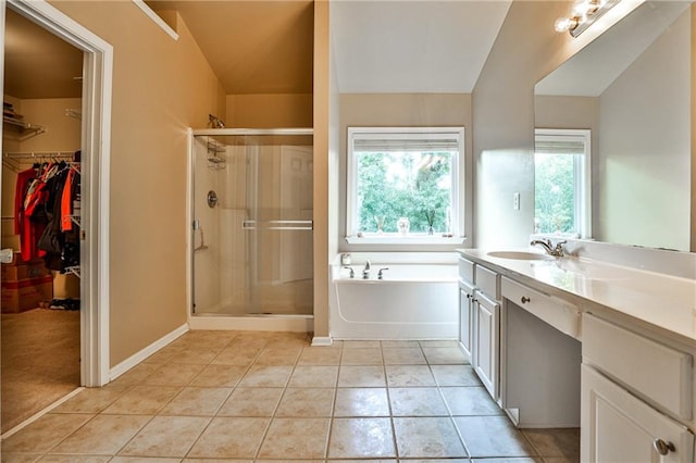 bathroom with tile patterned flooring, vanity, vaulted ceiling, and independent shower and bath