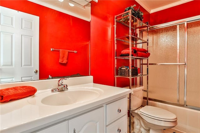 full bathroom with toilet, crown molding, vanity, and bath / shower combo with glass door