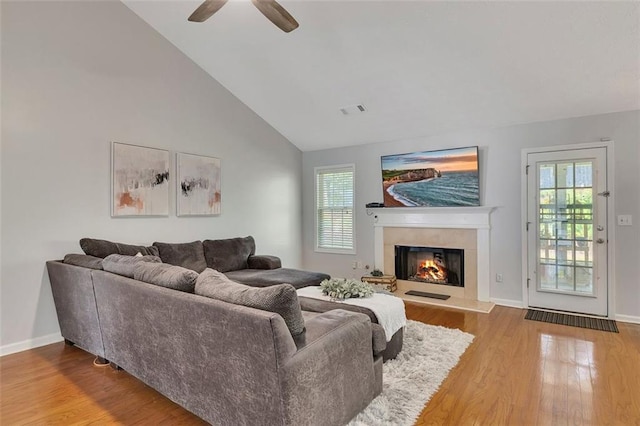 964 Natural Brook Trl, Lawrenceville, GA 30045 - living room featuring a warm lit fireplace, wood finished floors, ceiling fan, and high vaulted ceiling