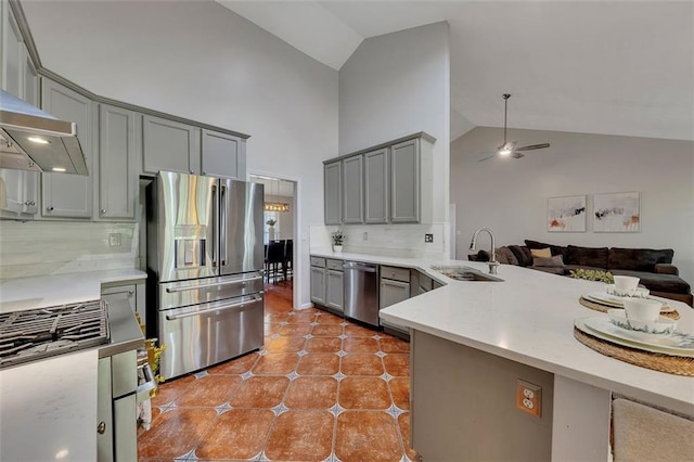 964 Natural Brook Trl, Lawrenceville, GA 30045 - kitchen featuring stainless steel appliances, gray cabinetry, high vaulted ceiling, backsplash, and open floor plan