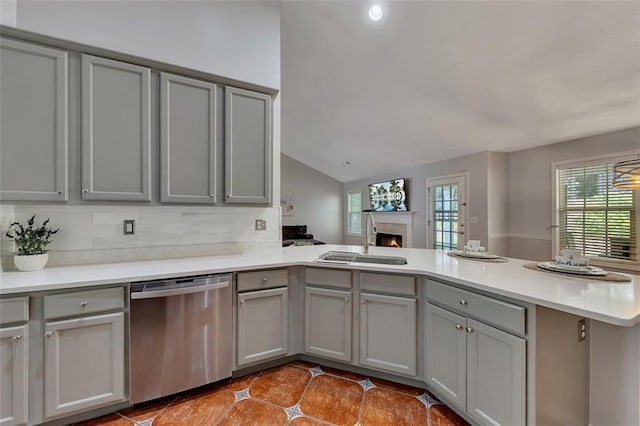 964 Natural Brook Trl, Lawrenceville, GA 30045 - kitchen with stainless steel dishwasher, gray cabinets, a peninsula, a lit fireplace, and lofted ceiling