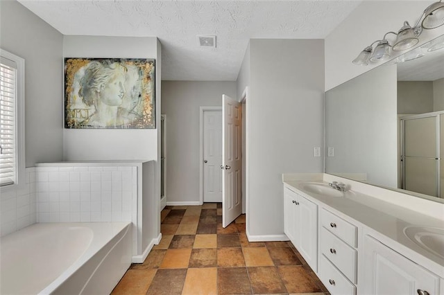 964 Natural Brook Trl, Lawrenceville, GA 30045 - bathroom with a stall shower, plenty of natural light, a bath, double vanity, and a textured ceiling