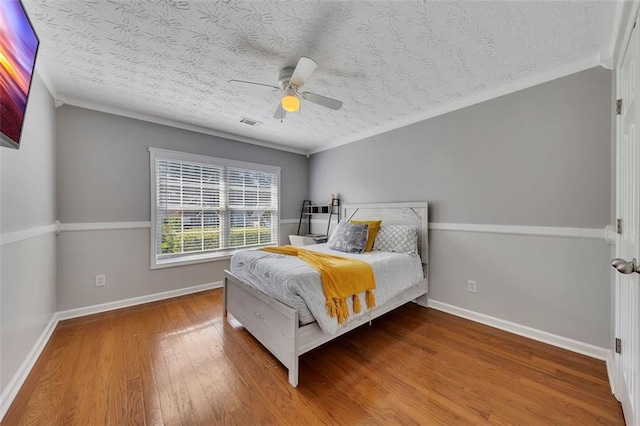 964 Natural Brook Trl, Lawrenceville, GA 30045 - bedroom featuring wood finished floors, a textured ceiling, ceiling fan, and crown molding