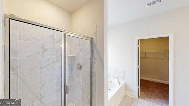 3402 Milan Ct Lot 1Plapprox Sqft 2, Douglasville, GA 30135 - bathroom with a bath, a shower stall, and a spacious closet