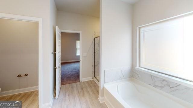 3402 Milan Ct Lot 1Plapprox Sqft 2, Douglasville, GA 30135 - full bathroom featuring a bath, wood finished floors, and a stall shower