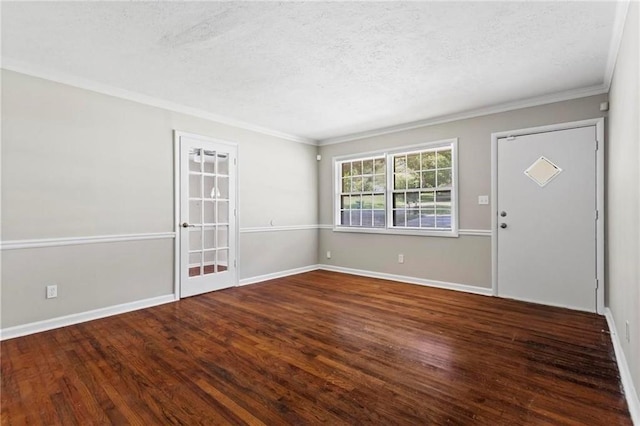 foyer entrance featuring dark hardwood / wood-style flooring, ornamental molding, and a textured ceiling