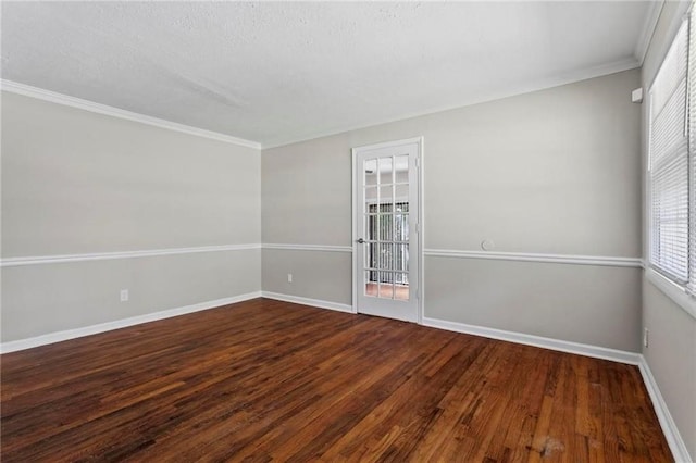 empty room featuring wood-type flooring and ornamental molding