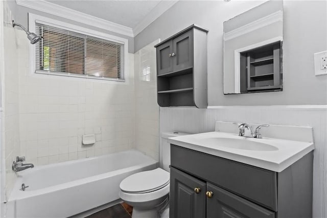 full bathroom featuring vanity, toilet, crown molding, and tiled shower / bath combo