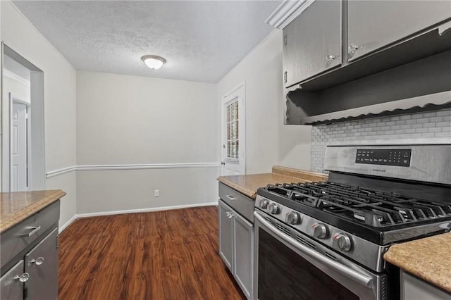 kitchen featuring dark hardwood / wood-style flooring, a textured ceiling, gray cabinets, and stainless steel gas range oven